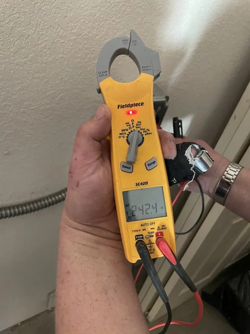 Voltage testing with clamp meter during Outlet Installation in Forsyth